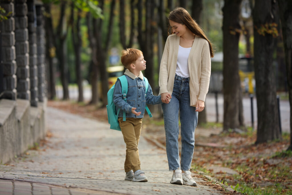Young mom taking her son to school